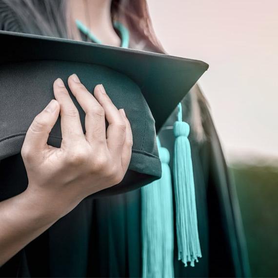 Caucasian female holding a graduation cap - Connections Academy