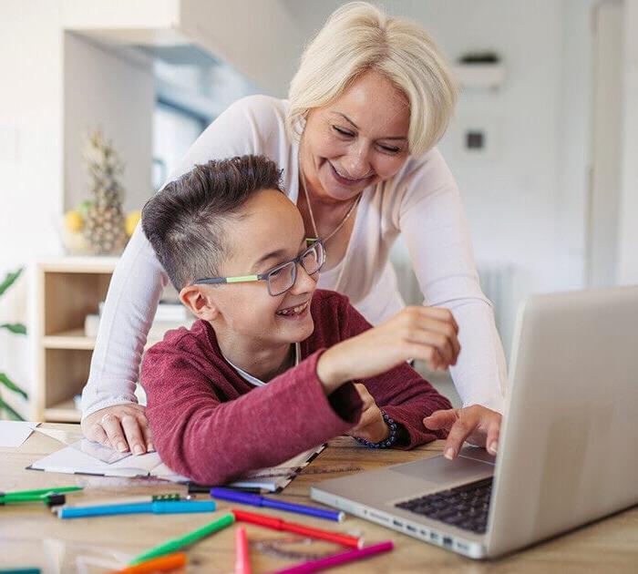 Mother and son studying together on a laptop - Connections Academy